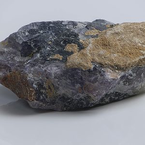 Detailed macro photo of a raw amethyst rock showcasing its unique crystal formations and textures.